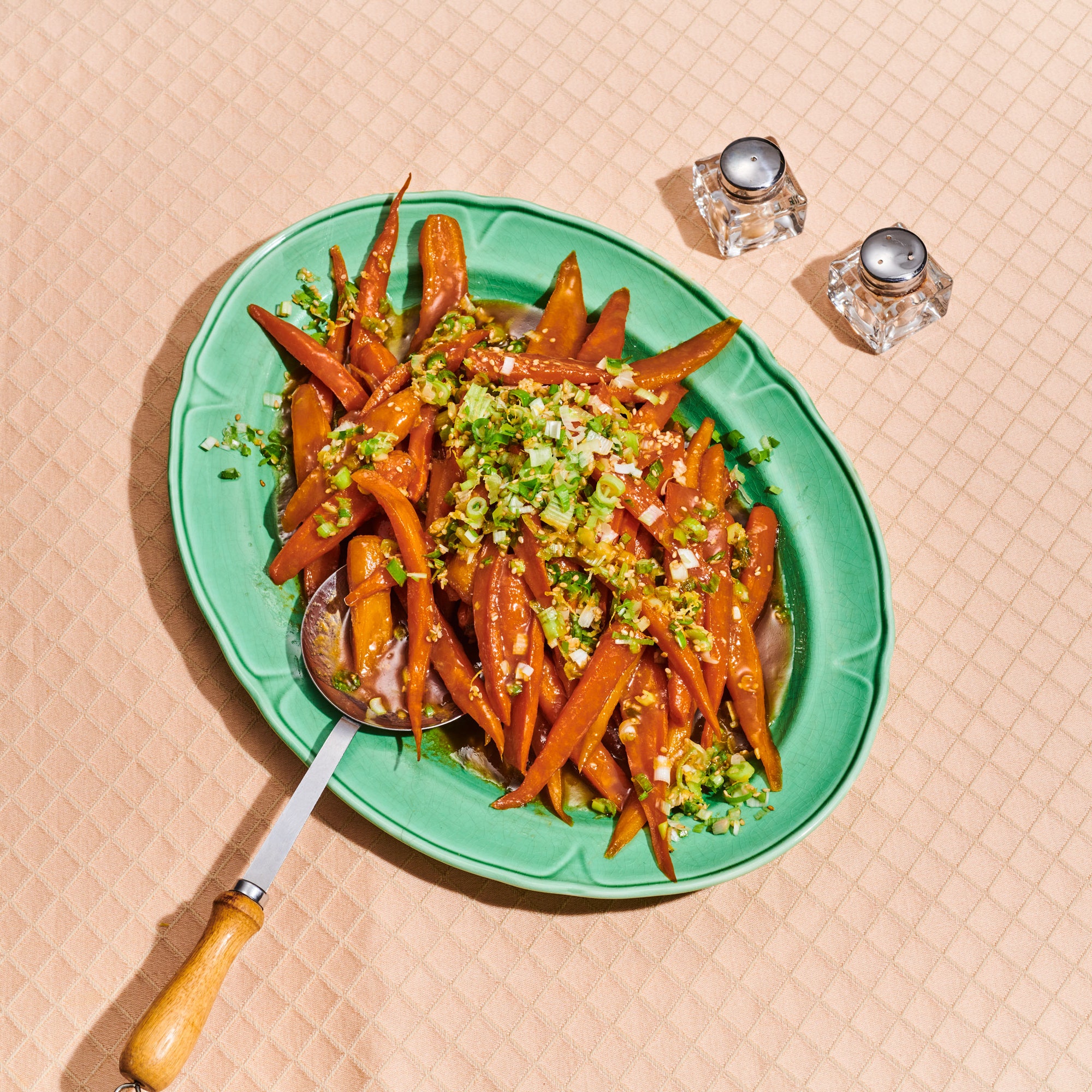 Miso glazed carrots with scallion gremolata on a platter