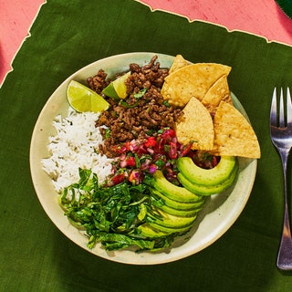 Beef Taco Bowl in a white bowl on a green surface