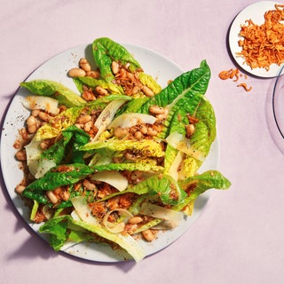 Leaves and beans together on a plate with Parmesan on the side